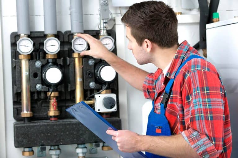 Technician reparing heating system -Big Easy HVAC